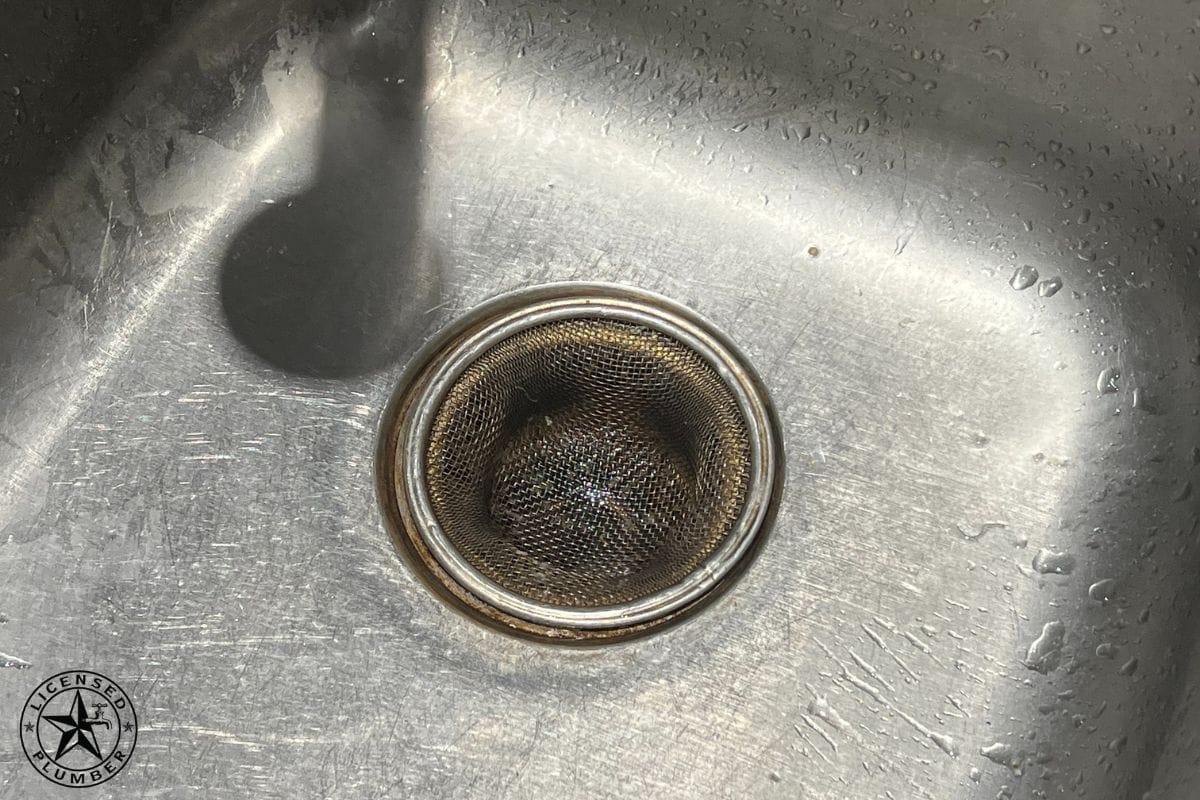 plumber cleaing a clogged drain in a Rosenberg TX home